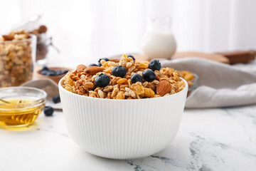Bowl with tasty granola on table