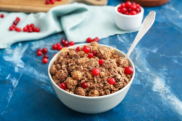 Bowl with tasty granola on color background