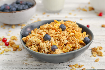 Bowl with tasty granola on table