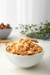 Bowl with tasty granola on table