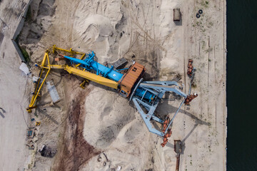 A river crane for loading sand fell to the ground. Photo from a drone.