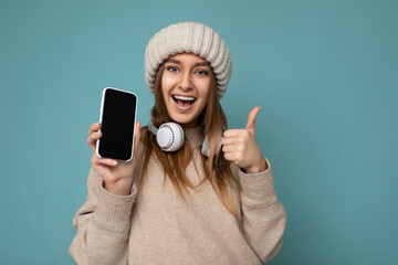 Photo of attractive positive joyful young dark blonde woman wearing beige stylish sweater and...