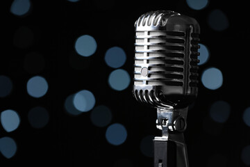 Retro microphone against defocused lights, closeup