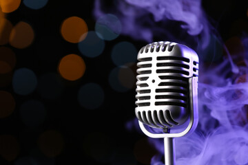 Retro microphone against defocused lights, closeup