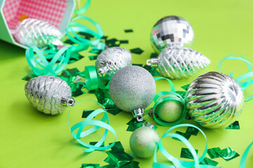 Christmas decor and confetti on color background, closeup