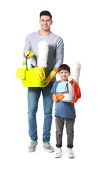 Fototapeta premium Father and son with cleaning supplies on white background