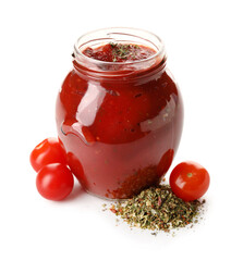 Glass jar of tasty tomato sauce and spices on white background