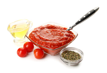 Glass bowl of tasty sauce, oil and spices on white background