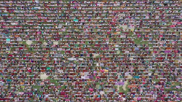 Aerial view of a vast crowd of people worshipping at Gore Shahid park in front of Eid Gah Minar religious site in Dinajpur, Rangpur, Bangladesh.