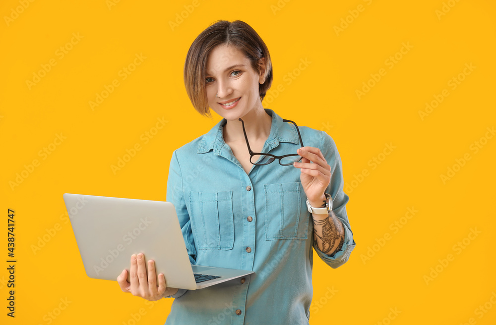 Wall mural female programmer with laptop on color background