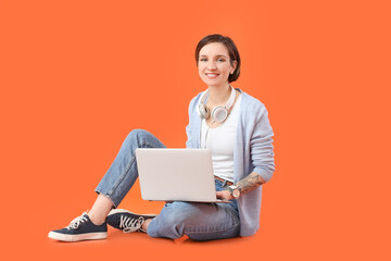Female programmer with laptop on color background