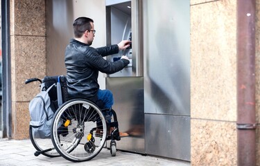 man in wheelchair using atm bank machine