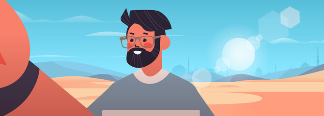 happy man taking selfie on smartphone camera guy making self photo desert landscape background