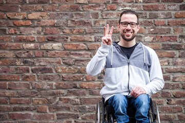 man in wheelchair counting on his fingers