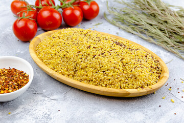 uncooked bulgur in wooden bowl