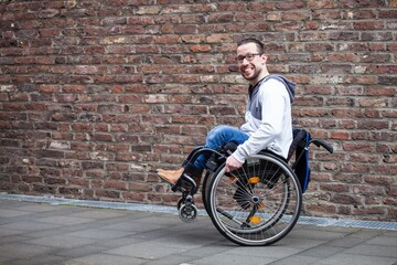 man in wheelchair doing a wheelie