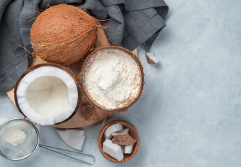 Coconut flour and coconut on a gray background. - obrazy, fototapety, plakaty