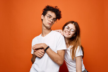 young couple in white t-shirts and glasses fun communication joy