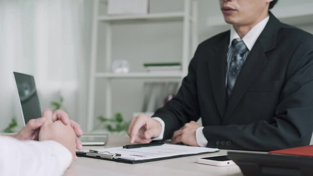 Executives accept resume and review job applicants resume to match the job position.The executives expressed their joy and shack hands with the interviewees were recruited for the job.