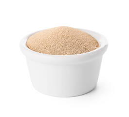Bowl with active dry yeast on white background
