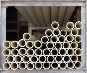 Background of white plastic pipes used at the building site.