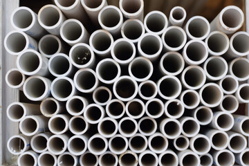 Background of white plastic pipes used at the building site.