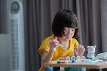 asian kid paint color on paper, education concept