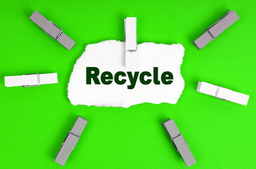 Clothespins and a sheet of paper with the inscription- recycle