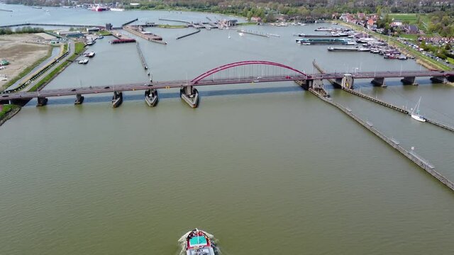 Aerial view of Schellingwouderbrug and liquid transporting tank barge moving towards infrastructure this bridge is located in Amsterdam-Noord is a borough of Amsterdam the Netherlands 4k quality
