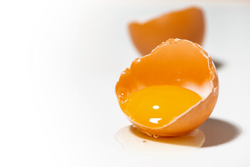 broken fresh chicken egg on white background
