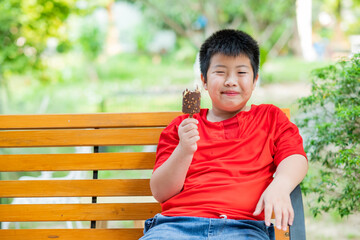 asian boy eating ice cream, summer season