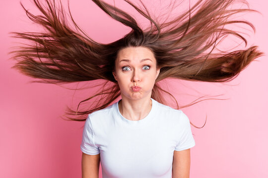 Photo of funky funny silly playful woman with flying hair hold breath fooling around isolated on pink color background