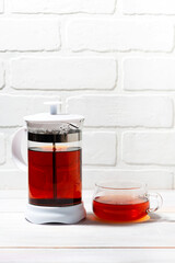 fresh black tea in French press on white background, vertical