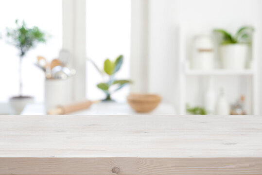 Wooden texture table on blurred kitchen window sill and shelf