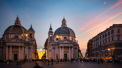 Piazza del Popolo Rome city at night. View of two cathedrals during sunset