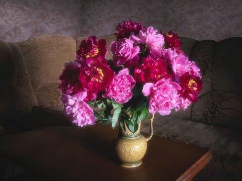 A bouquet of peonies in the interior of the living room