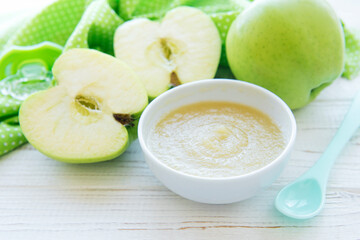 Bowl with fruit baby food and apples