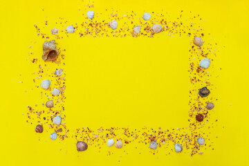 Sea shells frame on yellow background