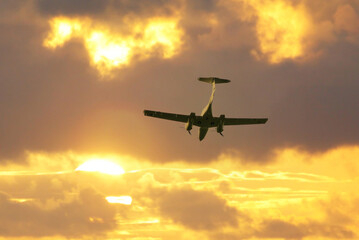 Airplane in the sky, sunrise or sunset sky background