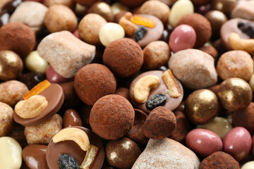 Different delicious chocolate candies as background, closeup