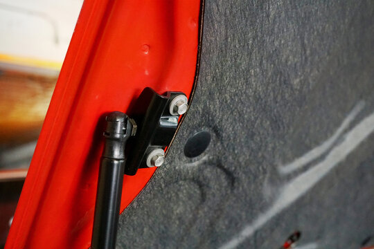 Red Car Trunk Shock Absorber Close-up