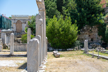 Columns in the Roman Agora, ancient square in Athens, Greece, Europe. Panorama of old Greek ruins at Plaka district in Athens city center. 