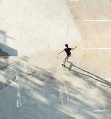 High angle view of woman riding on surf skate or skateboards outdoors on street. 