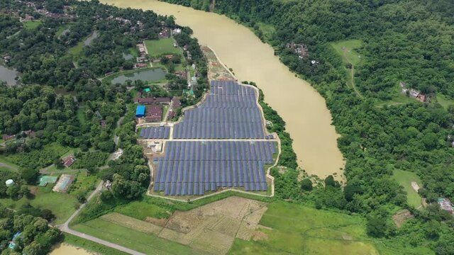 Aerial view of solar panels blue pattern along Karnaphuli river in Kaptai, Chittagong state, Bangladesh.