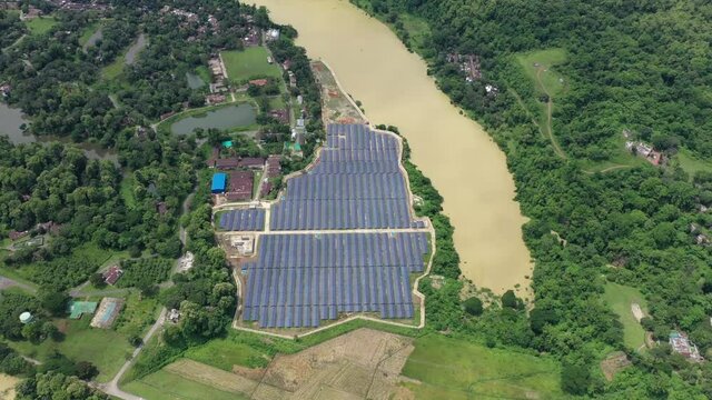 Aerial view of solar panels blue pattern along Karnaphuli river in Kaptai, Chittagong state, Bangladesh.