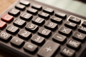 Black calculator on texture background stock image.