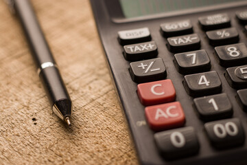 Black calculator on texture background stock image.