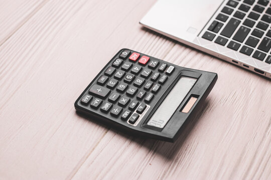 Black calculator on texture background stock image.