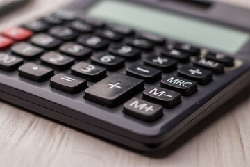 Black calculator on texture background stock image.