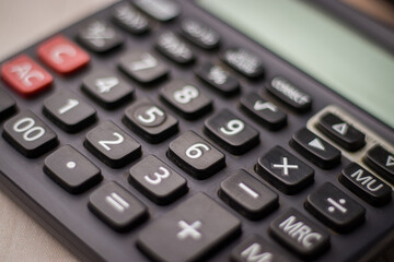 Black calculator on white background isolated stock image.
